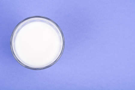 Glass with milk on bright backgroundの写真素材
