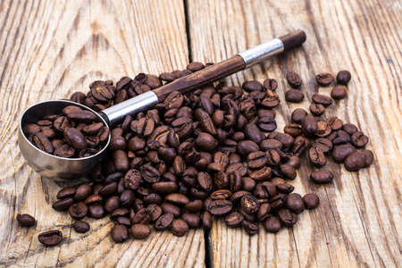 Bunch of coffee beans on wooden tableの写真素材