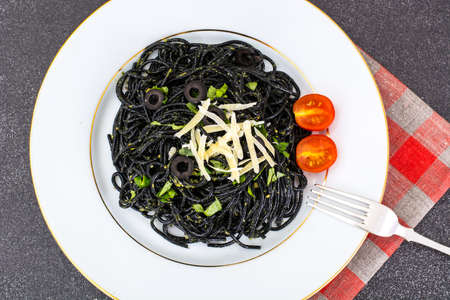 Black spaghetti with pesto sauceの写真素材