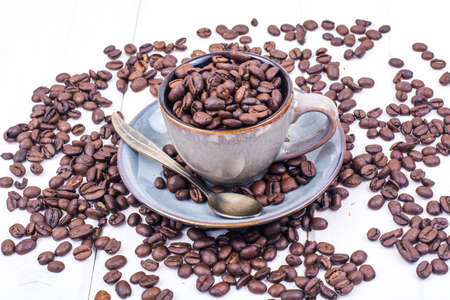 Cup full of coffee beans