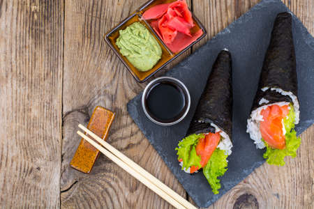Tasty fresh sushi cone on black stoneの写真素材