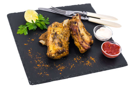 Pork ribs on black stone plateの写真素材