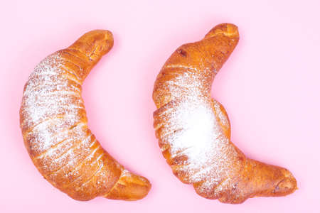 Fresh croissants sprinkled with powdered sugarの写真素材