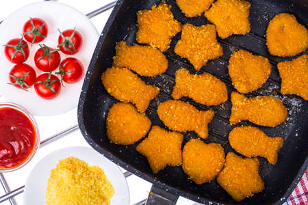 Fried fish sticks in frying panの写真素材