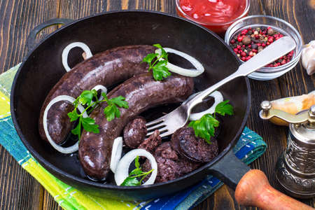 Hot blood sausage with onion on pan