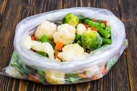 Frozen mixt of vegetables with Brussels and cauliflower, carrots, peas and beansの写真素材