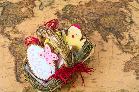 Easter  holiday travel on different countries. Beautiful glazed cookies, world map