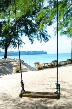 Suspended swings on the beachの写真素材