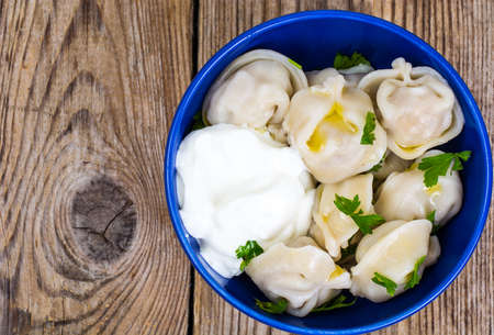 Cooked dumplings in blue bowlの写真素材