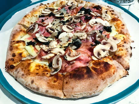 Delicious pizza with parma, champignons and pieces of black truffle. Studio photoの写真素材