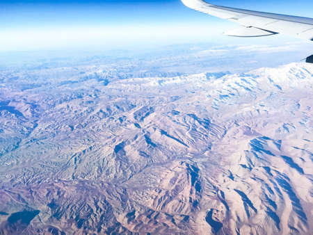 Mountains in the airplane windowの写真素材