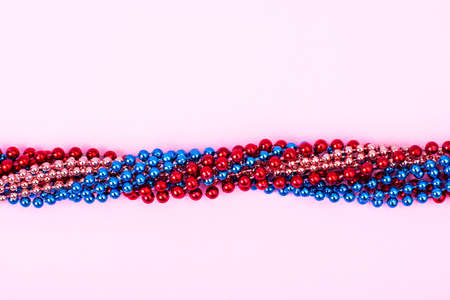 Multi color Mardi Gras beads on bright backgroundの写真素材