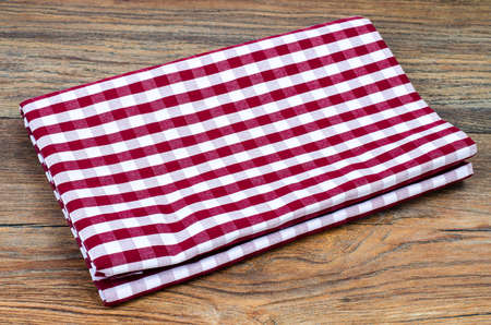 Tablecloth in white and red cage on wooden tableの写真素材