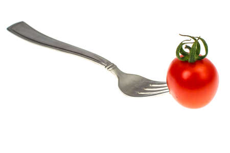 Image of red cocktail tomatoes on fork. Concept of vegetarian foodの写真素材