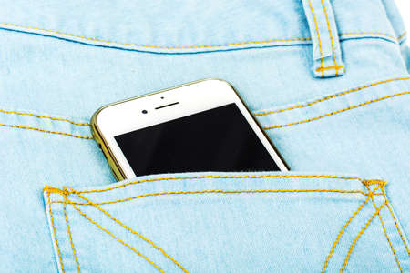 Mobile phone in the pocket of the blue jeansの写真素材