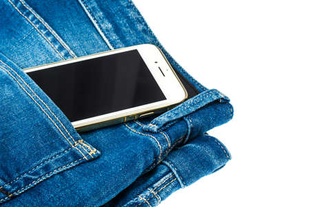 Mobile phone in the pocket of the blue jeansの写真素材