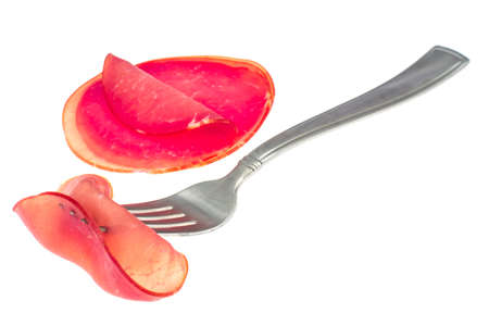 Slice of smoked ham on forkの写真素材