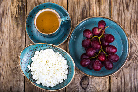 Useful breakfast with cottage cheese and grapes. Studio Photoの写真素材