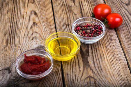 Tomato paste, ketchup, cherry tomatoes on wooden table. Studio Photoの写真素材