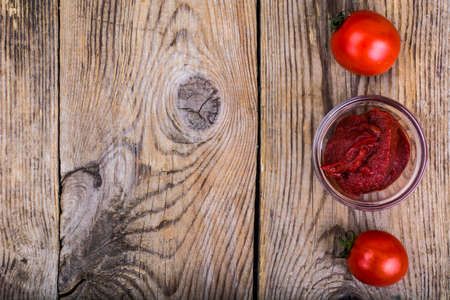 Tomato paste, ketchup, cherry tomatoes on wooden table. Studio Photoの写真素材