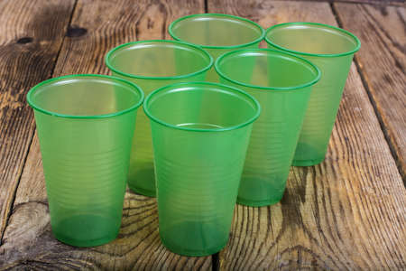 Plastic disposable tableware on wooden table. Studio Photoの写真素材