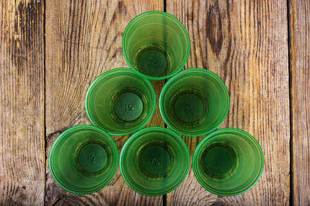 Plastic disposable tableware on wooden table. Studio Photoの写真素材