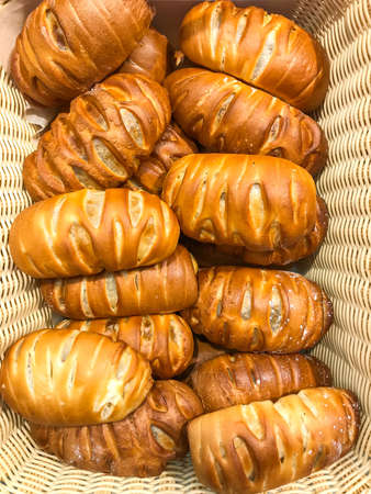 Sweet fresh buns with fruits and raisins in basket. Studio Photoの写真素材