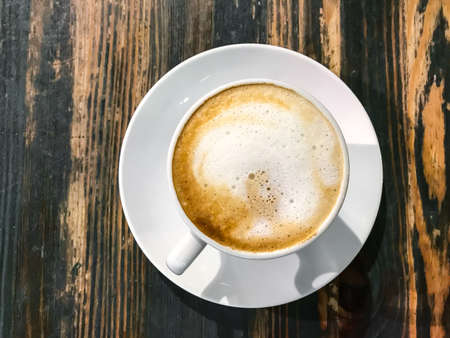 Cappuccino in white cup on old wooden table. Studio Photo
の写真素材