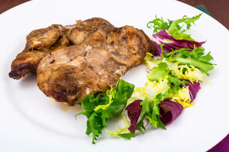 Concept of protein-carbohydrate nutrition. Chicken meat with lettuce. Studio Photo