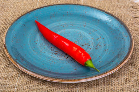 Pod of red chili peppers on fabric background. Studio Photoの写真素材