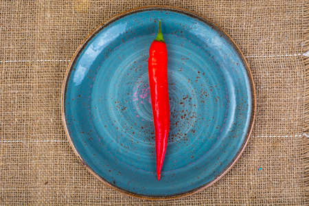 Pod of red chili peppers on fabric background. Studio Photoの写真素材
