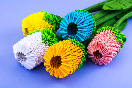 Origami bouquet of multicolored flowers on violet background. Studio Photoの写真素材