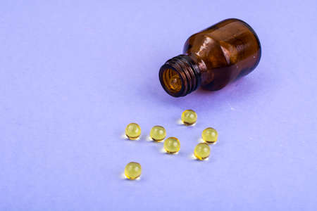 Color pills and pills on lilac background. Studio Photoの写真素材