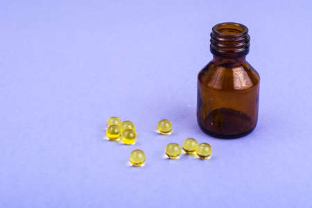 Color pills and pills on lilac background. Studio Photoの写真素材