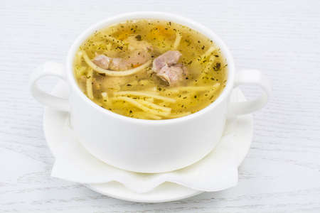 Chicken hot broth with vermicelli in white soup bowl. Studio Photoの写真素材