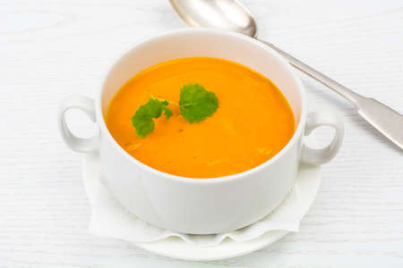 Cream soup of carrots, pumpkins, vegetables in white soup. Studio Photoの写真素材