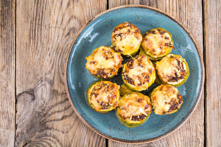 Zucchini stuffed with meat and cheese on blue plate. Studio Photoの写真素材