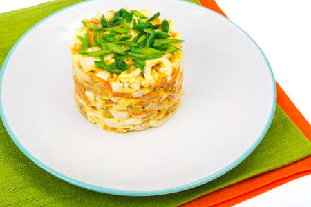 Portion salad with squid on plate,napkinsの写真素材