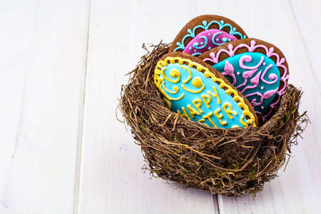 Symbols of the holiday Easter-nest, eggs, cookiesの写真素材