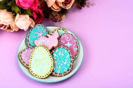 Easter homemade baked gingerbread cookies in the form of eggs with different pattern of icing on...