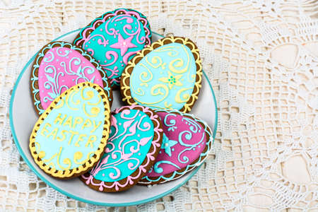 Easter homemade baked gingerbread cookies in the form of eggs with different pattern of icing on...