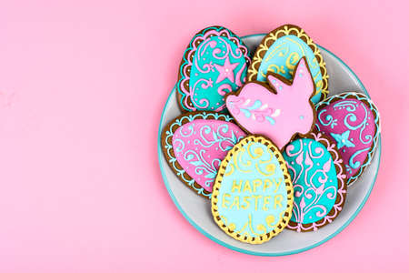 Easter homemade baked gingerbread cookies in the form of eggs with different pattern of icing on...