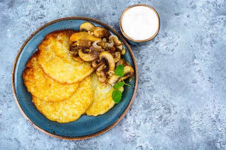 Hot potato pancakes with fried mushrooms