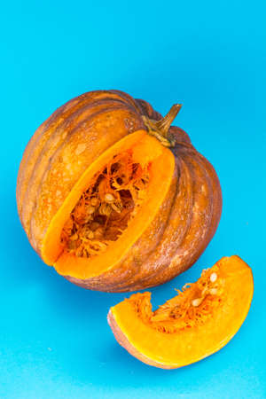 Sliced ripe pumpkin on blue wooden tableの写真素材