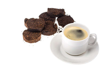 White cup with espresso, waste from the coffee machine