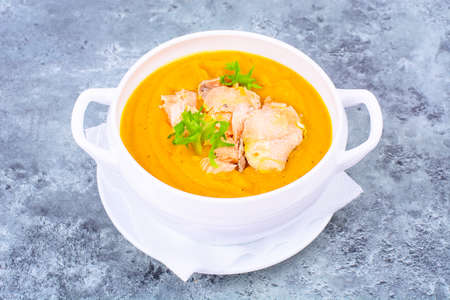 Pumpkin cream soup with slices of salmonの写真素材