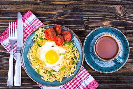 Breakfast. Spaghetti, fried egg, tomatoesの写真素材