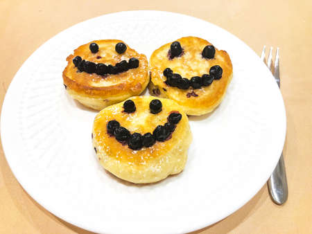 Breakfast for child. Delicious sweet pancakes with syrup, blueberriesの写真素材