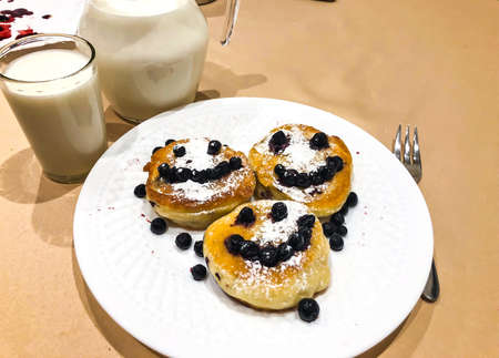 Breakfast for child. Delicious sweet pancakes with syrup, blueberriesの写真素材