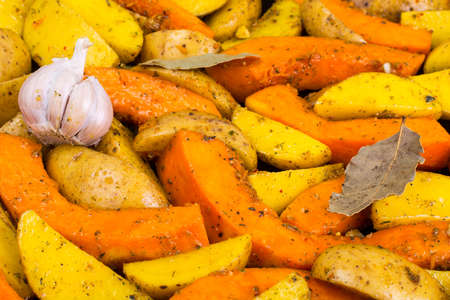 Sliced potatoes and pumpkin for baking in the ovenの写真素材